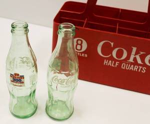 lot 82 image: Vintage Coca Cola Bottles Plastic Holder Comes With 2 Coca Cola 16 Ounce Empty Bottles