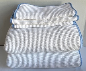 White Woven Bath Linens with Light Blue Accents