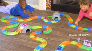 lot 55 image: Magic Tracks Deluxe Kit w 68 Accessories, 20 Glow-in-the-Dark Track & 2 Race Cars