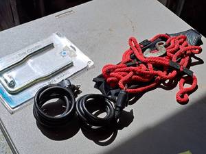 lot 566 image: Lot of (3) Misc. Items - Koeller Spare Tire Carrier Mount (in original package), Tow Rope, Cable Locks (x2)