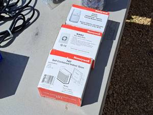 lot 656 image: Lot of (3) Honeywell Home Security Products (in original packaging) - Self Contained Indoor Siren #747, Wave2 Two-Tone Alarm, Passive Infrared Motion Sensor