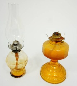 lot 27 image: (2) Vintage Amber Glass Hurricane Lamps