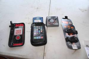 lot 474 image: Lot of (4) Bike Accessories (in original packaging) - Banjo Brothers Touch Screen Phone Case, BiKase Handy Andy 5 Phone Case, Oi Bicycle Bell, Anywere Adapter