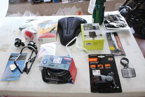 lot 515 image: Lot of (15) Bike Accessories (in original packaging) - Locks, Adapters, Lights, Mirrors, Seat, Bottle, Bottle Holders, Phone Mounts and more