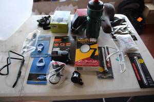 lot 519 image: Lot of (15) Bike Accessories (in original packaging) - Spoke Tools, Locks, Adapters, Lights, Mirrors, Seat, Bottle, Bottle Holders, Phone Mounts and more