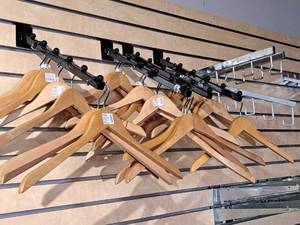 lot 1711 image: Lot of (7) 16 Slat Wall Clothes Hanger Brackets with Hangers