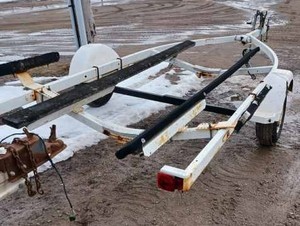 lot 63 image: White Boat Trailer - Needs New Wheel Bearings, will need to be hauled, not towed