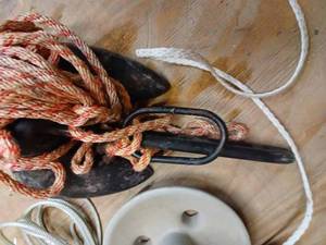 lot 123 image: Four Assorted Boat Anchors including a Black Coated Anchor, 2 Small Roloff Anchors, Roll of New Cable, And Nylon Rope and Anchor