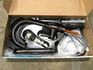 lot 3 image: Noell Single-Handle Standard Kitchen Faucet with Side Sprayer in Mediterranean Bronze by MOEN Customer Returns See Pictures