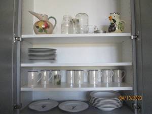 Cupboard of plates mugs and more. i...