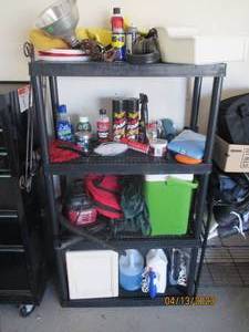 Storage shelf filled with garage go...