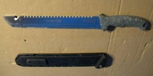 lot 13 image: Camillus Carnivore-X 18 Machete, 12 Cutting Blade, 10 Saw, Gray Handle, Molded Sheath,