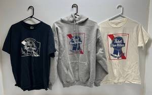 lot 26 image: Three Pabst Blue Ribbon Advertisement Shirts 1 White Large T-Shirt 1 Black XL T-Shirt 1 Xl Grey Hoodie Sweatshirt