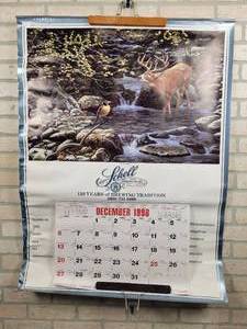lot 461 image: 1986 Schells Beer Wall Calendar - New Ulm, MN - Approx. 31 x 42 - Features River Crossing by Artist J. Van Straalen - Lists the Blizzard Ale that Dairy Queen Sued Schells Brewery Over