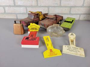 lot 699 image: Vintage TONKA Trucks, Advertising Ice Scrapers, Glass Piggy Bank and Small Cowbell