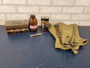 lot 1458 image: WW2 Canvas Dismounted Leggings, Schmidt Beer Bottle, Schells Beer Can, Vintage Chocolates Tin and Schmidt Bottle Opener