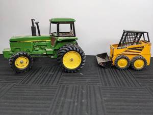 lot 13 image: Vintage Green John Deere Tractor and Yellow John Deere Skid Steer Loader Toys