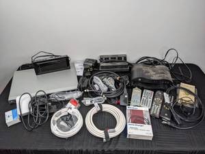 lot 112 image: Assorted Cables, Chargers, Remote Controls, Magnavox DVD Player, GE Converter Boxes, Best Buy AMFM Alarm Clock Radio