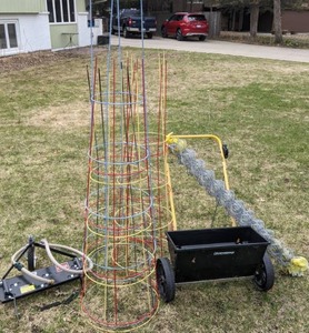 lot 118 image: Yardworks Seed Spreader, Assorted Tomato Cages and Wires, Small Hose, and Toro Front Mount Thatcher Attachment