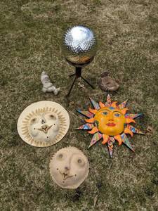 lot 119 image: Assorted Garden and Outdoor Decor - Short Mirrored Golf Ball Globe, Sun, MaskFaces, Relaxed Gnome, Bird