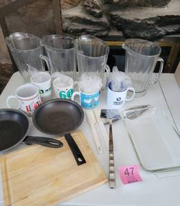 lot 47 image: 4 Glass Pitchers-5 Decorated Coffee Cups-2 Small Frying Pans-Pancake Turner-2 Spatulas-Cutting Board-9 x 13 Glass Cake Pan