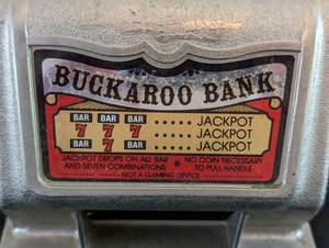lot 144 image: Vintage Nevada Buckaroo Slot Machine Bank