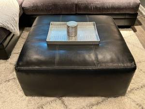 lot 4 image: Ashley Furniture Black Faux Leather Ottoman