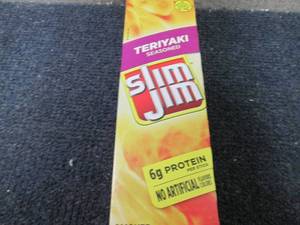 lot 231 image: Box of 24- 0.97 oz Slim Jim Teriyak...