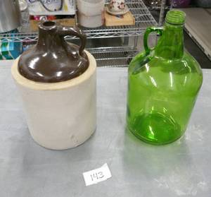 lot 143 image: Vintage whiskey jug in real good shape and green gallon jug also very good