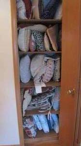 Closet filled with decorative pillows