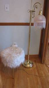 Brass toned metal base floor lamp
