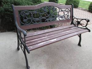 Park bench with metal backrest