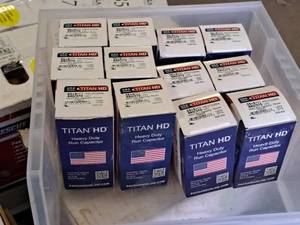 lot 82A image: Lot of (12) Titan HD 440370V Motor Run Capacitor - Round (in original packaging)