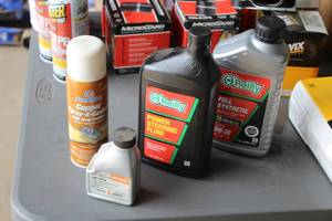 lot 518 image: Lot of (4) Automotive Fluids - O-Reilly Power Steering Fluid, O-Reilly Full Synthetic Motor Oil 5W-20, Stihl Two-Cycle Oil, Permatex Copper Spray-a-Gasket