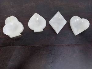 lot 15 image: Set Of Four Stone Playing Card Suit Themed Ashtrays