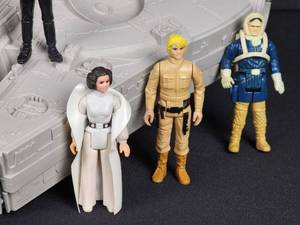 lot 53 image: Vintage (9) Assorted 1970s Original Star Wars Action Figures and (1) Later Edition Star Wars Action Figure with Millenium Falcon Carring Case
