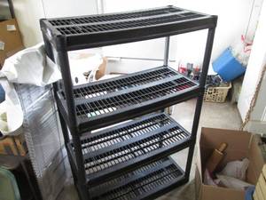 4-tier black plastic storage shelf.