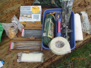 Top handle Cleaning caddy full of  large galvanized nailsspikesstakes,