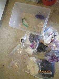 Clear Rubbermaid box with a variety of assorted decorative materials