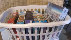 lot 66 image: laundry basket full of puzzles, som...