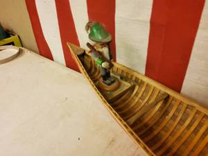 Red hand made wood  Canoe with nut craker hunter.