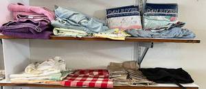 lot 163 image: Two Shelves Full Of Misc. Household Items Including Bath Towels, Table Cloths Sheet Sets And More