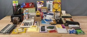lot 148 image: Office Supplies  Pencil Sharpeners, Calculator, Scissors, Post-It Notes, Stapler, Staples, Hole Punch, Magnifying Glass, and More  R