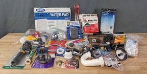lot 200 image: Assortment of New Plumbing Repair Parts (Drain Assembly, Shower Heads, Drain Pipe Auger, Oatey Wax Bowl Ring and More) R
