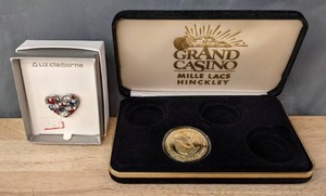 lot 280 image: Liz Claiborne Heart Brooch and Grand Casino Mille Lacs Hinckley Humpback Whale Coin J