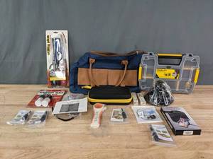 lot 297 image: Collection of Household Garage Items Radon Test, NEW Stanley, Jump Starter, Windshield Crack Repair, Car Tool, Lighters, Etc. R