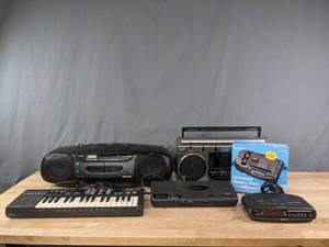 lot 313 image: Vintage Sony Stereo, Casino SK-1 Keyboard, Panasonic CD Player, Sony Dream Machine, GE Stereo, Radio Shack Universal Battery Pack  R