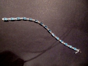 lot 103 image: ETERNA GOLD 14K GOLD TENNIS BRACELET WITH BLUE STONES
