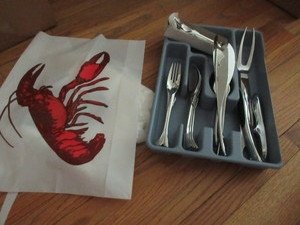 lot 409 image: YAMACO, STAINLESS STEEL, FISH THEMED FLATWARE AND NEW PLASTIC LOBSTER BIBS