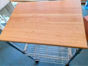 lot 10 image: Stainless Steel Kitchen Prep Cart with Wood Top on Casters, Measures 34.5-inches tall X 15-inches wide X 21-inches